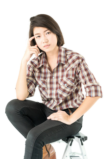 Young pretty woman in plaid shirt posing in studio with isolated on white background - Photo, Image