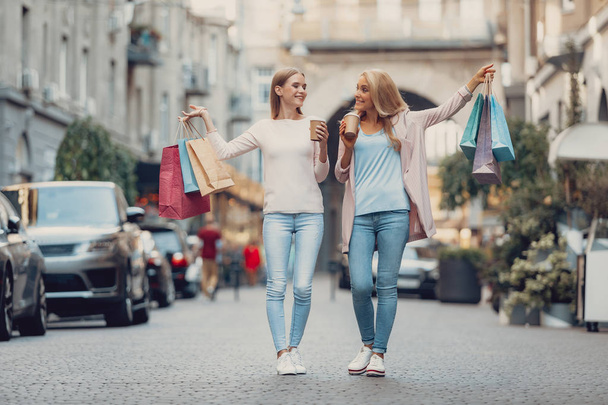Cheerful middle-aged lady and her daughter enjoying shopping - Valokuva, kuva