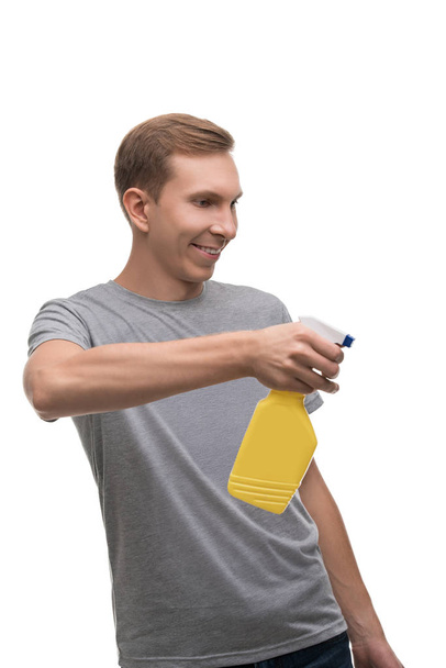 Happy man with water sprayer isolated portrait - 写真・画像