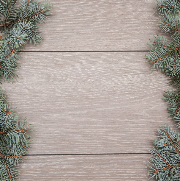Pinecones and pine's branches on wooden background. - Photo, Image