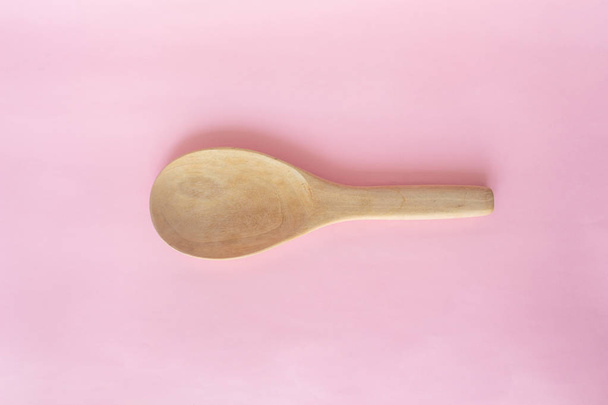 wooden ladle spoon on pink background rose quartz - Zdjęcie, obraz