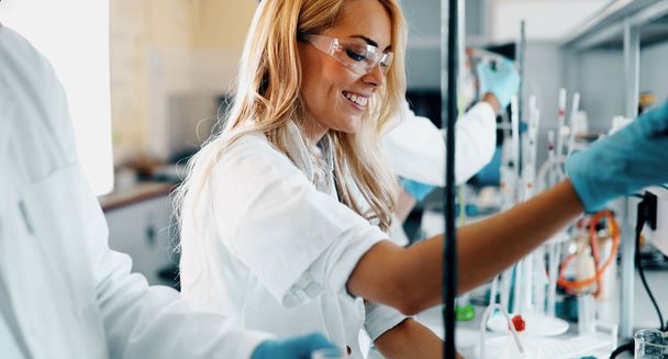Attractive female student of chemistry working in laboratory - Photo, image