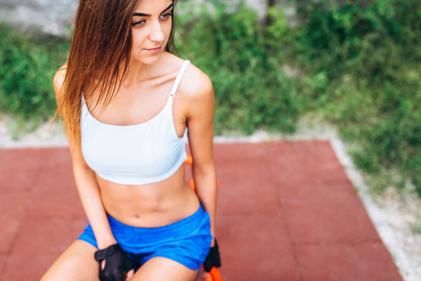 Pretty young sporty girl workout outdoor on the street - Photo, Image