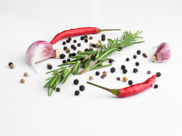 Red hot chilli pepper, garlic and rosemary with sea salt and colored pepper on white background - Foto, Bild