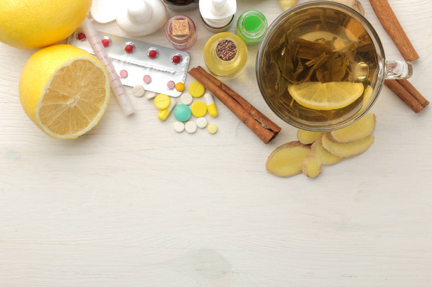 Various cold medicines and cold remedies on a white wooden table. Cold. diseases. cold. view from above - Foto, immagini