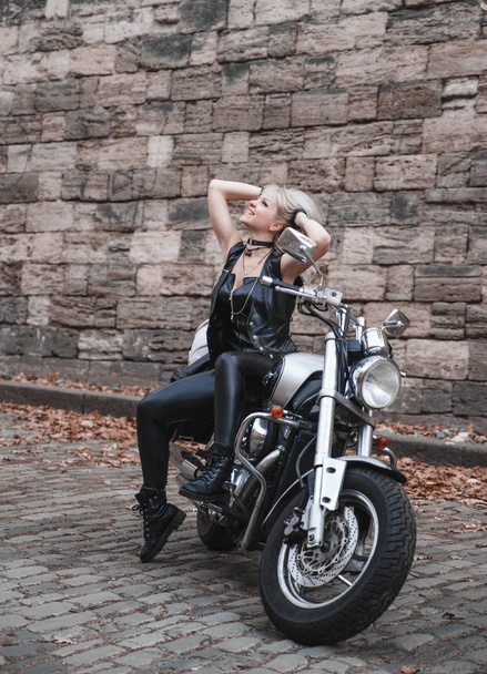Beautiful biker woman outdoor. - Фото, изображение