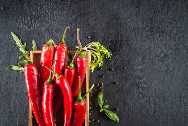 Hot spicy paprica pepper on black background - Φωτογραφία, εικόνα