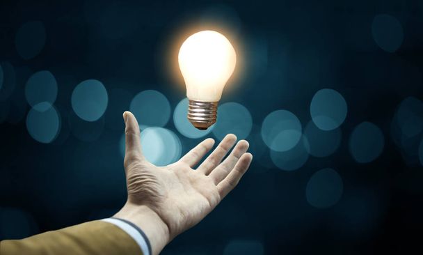 idea concept. Hand of businessman with  light bulb - Fotoğraf, Görsel