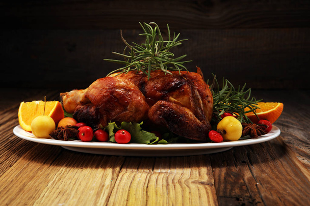 Baked turkey or chicken. The Christmas table is served with a turkey, decorated with fruits, salad and nuts. Fried chicken, table. Christmas dinner.  - Photo, Image