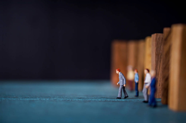Leadership Concept. Miniature Figure of Businessman Leading from another by Stepping Forward - Fotoğraf, Görsel