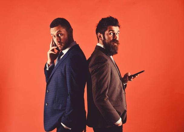 Business conversation concept. Machos in classic suits talk on phone - Φωτογραφία, εικόνα