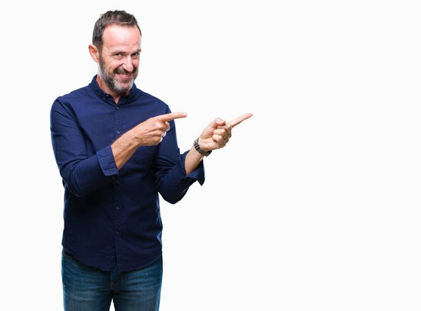 Middle age hoary senior man over isolated background smiling and looking at the camera pointing with two hands and fingers to the side. - Foto, Bild