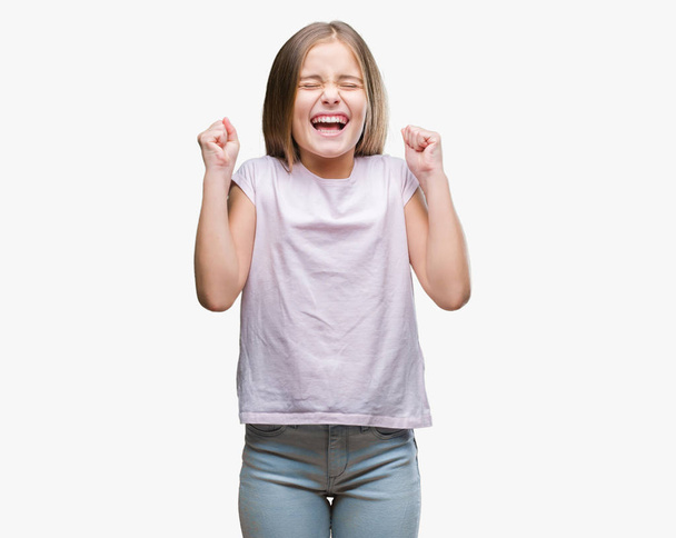 Young beautiful girl over isolated background excited for success with arms raised celebrating victory smiling. Winner concept. - Fotoğraf, Görsel