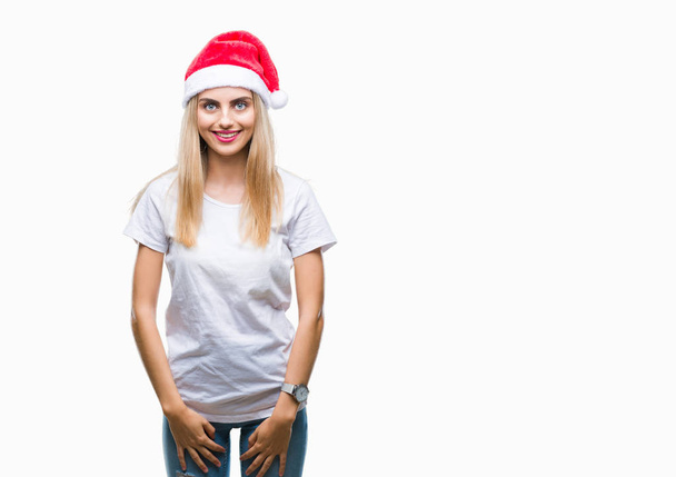 Young beautiful blonde woman christmas hat over isolated background with a happy and cool smile on face. Lucky person. - Photo, Image