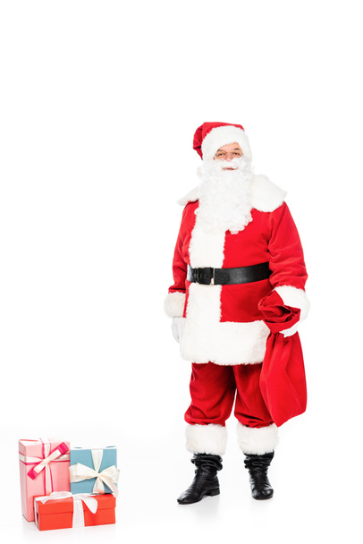santa claus with presents and bag looking at camera isolated on white - 写真・画像