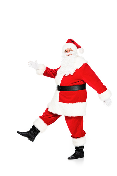 side view of santa claus walking and looking at camera isolated on white - Фото, изображение