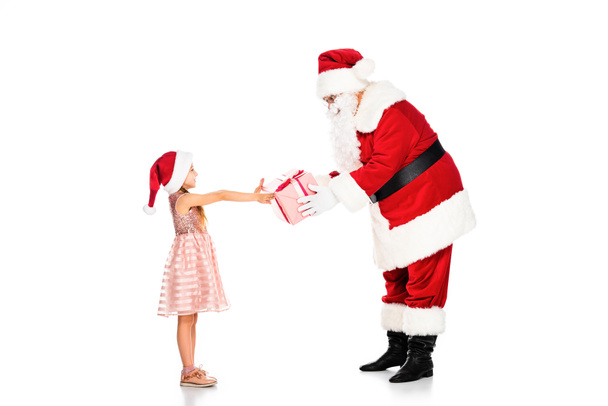 side view of santa claus giving present to little child isolated on white - Photo, Image