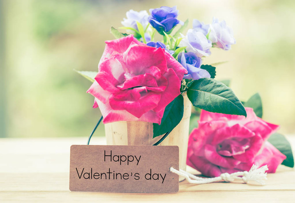 Writing happy valentine on card with rose on table. - Zdjęcie, obraz