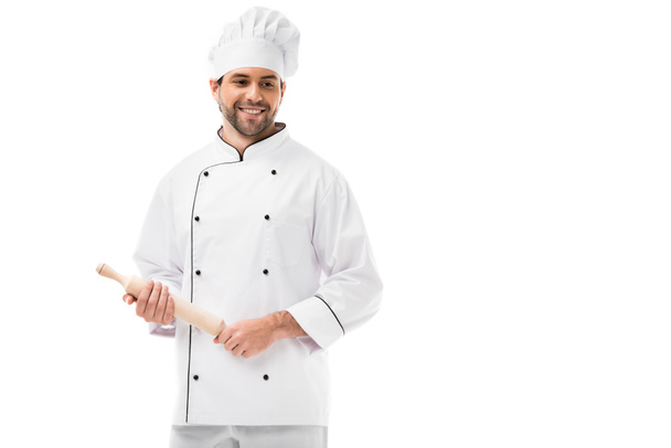 smiling young chef holding rolling pin isolated on white - Fotoğraf, Görsel