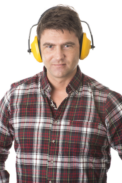Serious handyman with earmuffs on white background - Photo, Image