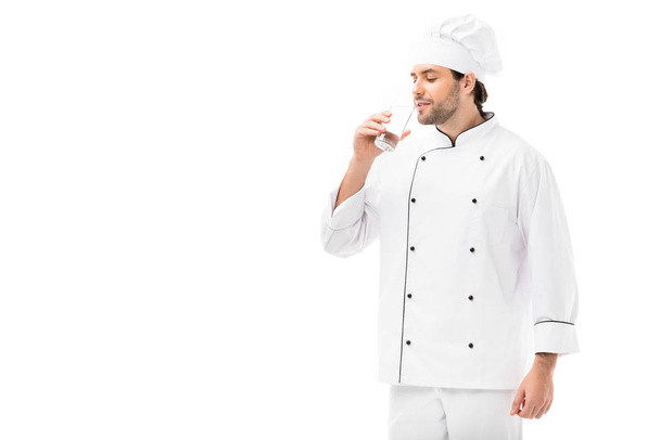 handsome young chef drinking water isolated on white - Photo, Image