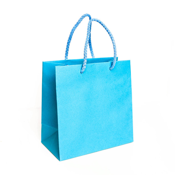 Blue paper bag isolated on white backgrund - 写真・画像