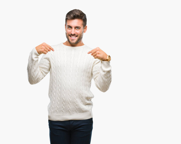 Young handsome man wearing winter sweater over isolated background looking confident with smile on face, pointing oneself with fingers proud and happy. - Photo, Image