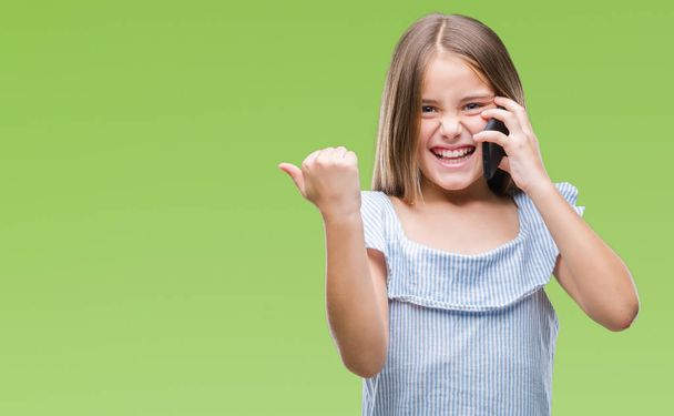 Young beautiful girl talking on the phone over isolated background screaming proud and celebrating victory and success very excited, cheering emotion - Foto, immagini