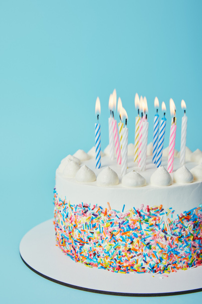 Birthday cake with lighting candles on blue background - Fotoğraf, Görsel