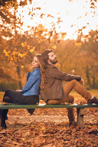Couple in autumn season colored park enjoying outdoors. - Photo, Image