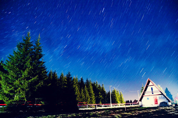 Sternenpfade mit den Silhouetten ländlicher Vororte bei Nacht. meine astronomische Arbeit. - Foto, Bild