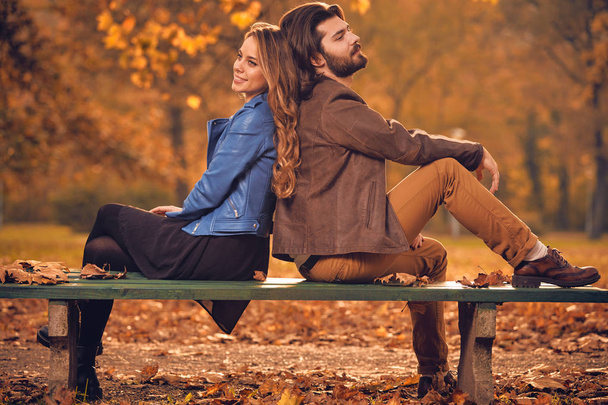 Couple in autumn season colored park enjoying outdoors. - Photo, Image