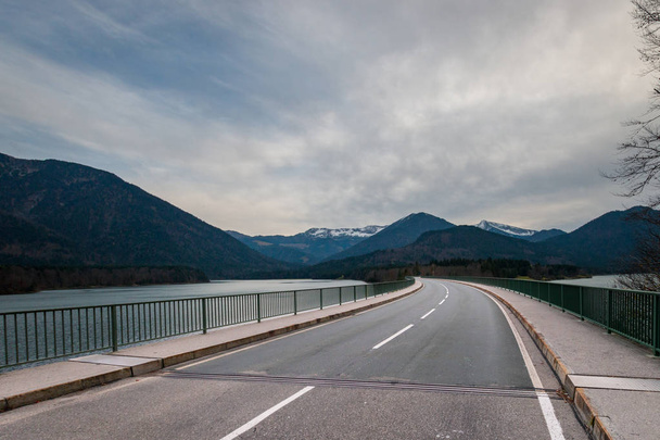 Country road along Faller Klamm Bridge across Lake Sylvenstein in the Alps in Bavaria, Germany - Photo, Image