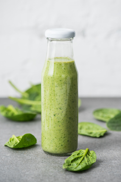 Green blended organic smoothie in glass bottle - 写真・画像