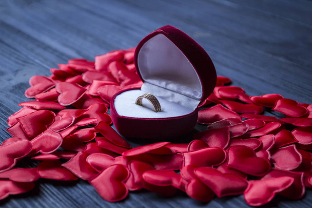 Engagement ring in a red box on a love hearts background. Valentine's day 2019. - 写真・画像
