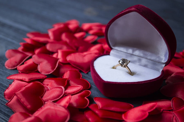 Engagement ring in a red box on a love hearts background. Valentine's day 2019. - 写真・画像