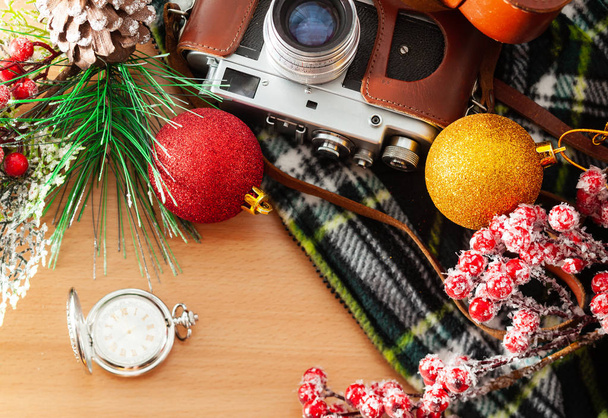 Pocket watch and retro camera on the table with Christmas decoration - Foto, Imagem