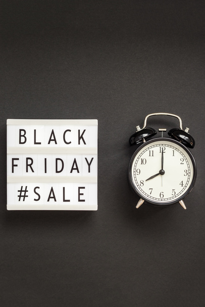 Creative Top view flat lay promotion composition Black friday sale text on lightbox alarm clock black background copy space Template Black friday sale mockup fall thanksgiving promotion advertising - Photo, Image