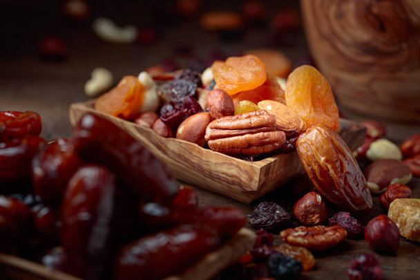Various dried fruits and nuts in wooden dish. - Photo, Image