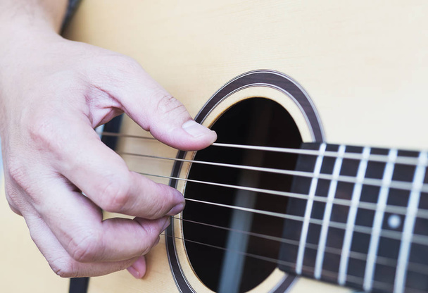 Closeup of man playing guitar - Photo, Image