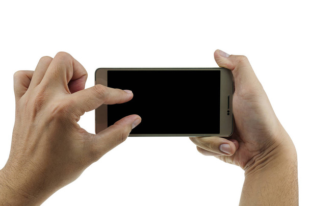 Isolated male hands holding mobile phone in blank black screen to take / watch / zoom photo. Mobile technology. Photo includes three clipping paths at outer edge, inner edge, and black screen. - Foto, Bild