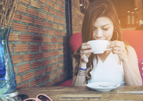 Lady drinking coffee in vintage coffee shop - Photo, image