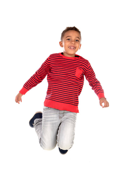 Happy latin child jumping isolated on a white background - Фото, изображение
