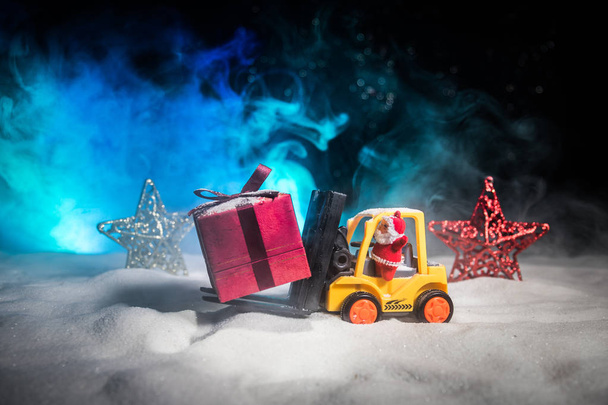 Miniaturní krabičky strojem vysokozdvižného vozíku na sněhu, určuje obrázek pro vánoční svátky a šťastný nový rok dárky oslava konceptu. Selektivní fokus - Fotografie, Obrázek