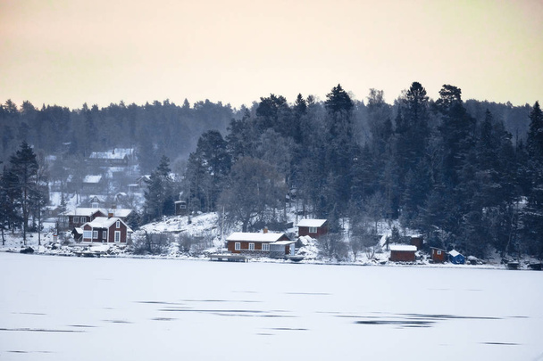 Sweden house in the wintertime. Nature on the shore of the fjord - Photo, Image