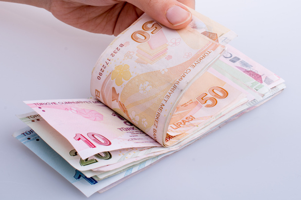 Billetes turksh lira de mano sobre fondo blanco
 - Foto, imagen