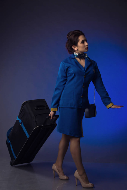 beautiful young pinup girl in suit of stewardess - Foto, Imagen