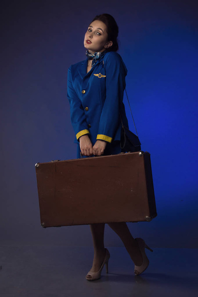beautiful young pinup girl in suit of stewardess - Фото, изображение