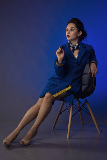 beautiful young pinup girl in suit of stewardess - Фото, зображення