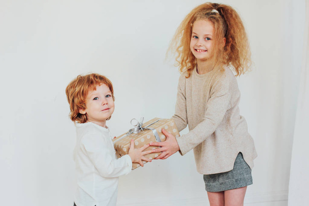 Sister gives gift to younger brother - Photo, Image